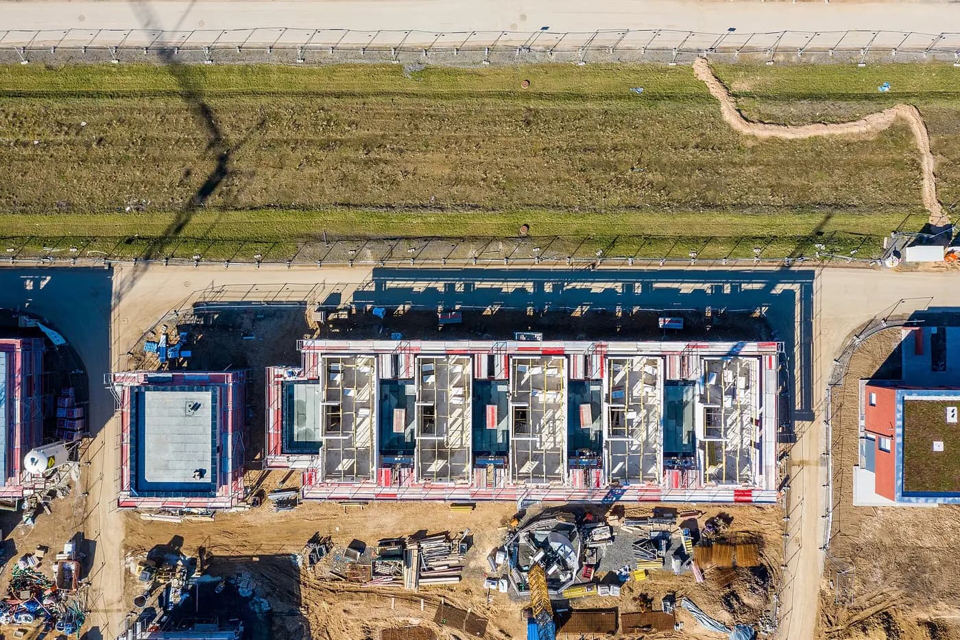 Straight-down drone photo of a townhouse block with its roof not yet on