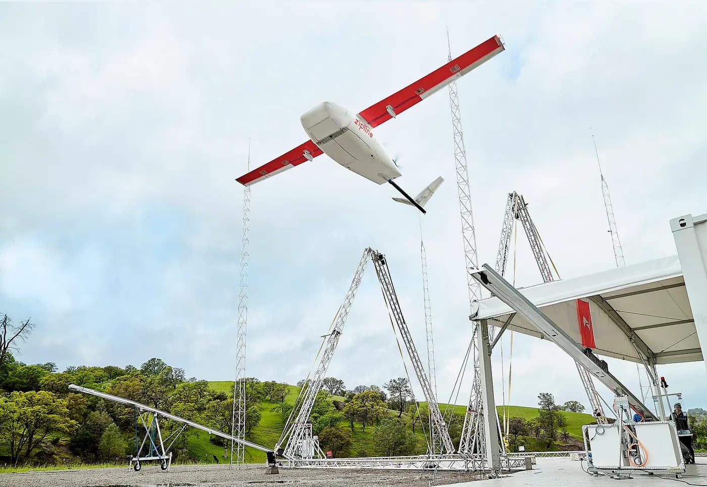 Fixed-wing delivery drone launching from a catapult rail