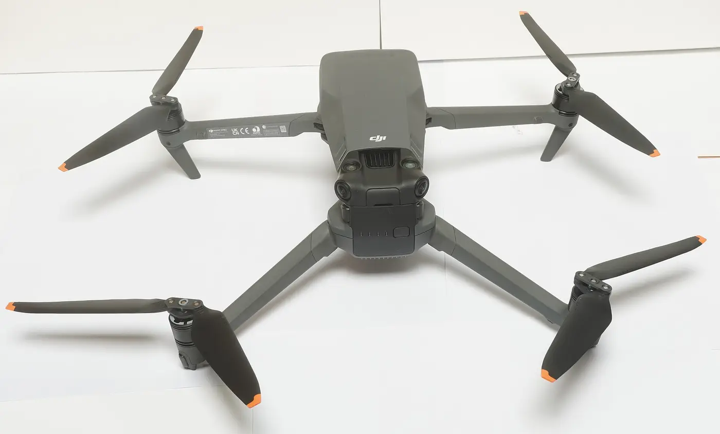 DJI Mavic 3 Pro seen from above, arms unfolded, on a white surface